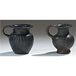 Vases. Two Italic miniature black-glazed olpai. Circa 4th century BC.  D/ 5.5 cm high.        Repair