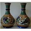 Image 1 : A Pair of Arnhem Bottle Vases, with Persian style decoration (one a. f.) 26 cm £20-30...