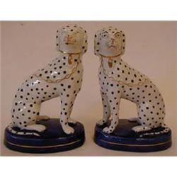 A Pair of Dalmatian Dogs, seated, with gilt chains, on oval blue bases, 16 cm, (2)  See illustrat...