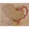 Image 1 : A Belleek Nautilus Shell, with a pink coral handle and pink interior, black printed mark (smudged...