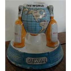 A Dewar's White Label Match Strike, in the form of a globe on three bottle supports (small chip),...