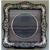 Image 1 : A Silver Mounted Photo Frame, with a circular inset frame, Chester 1904, 12.5 cm square £40-60...