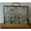 A Walker and Hall Plated Tantalus, with engraved decoration, and three numbered glass decanters a...