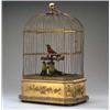 Image 1 : A Swiss Musical Bird Cage], the gilt metal domed rectangular cage surmounted by a ring handle, an...