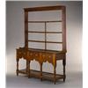 Image 1 : An Early 19th Century Dresser], the rack with coved cornice over four shelves, the base with thre...