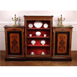 A Victorian Ebonised and Amboyna Credenza], the raised centre section set with red plush lined sh...