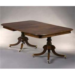 A Regency Mahogany Dining Table, comprising two D ends with moulded edges to the tops, raised on...