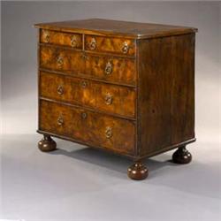 An Early 18th Century Walnut Chest], the ovolo-moulded top inlaid with strung quadrants and arcs,...