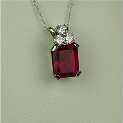 Gorgeous 14 karat white gold ladies pendant  set with an emerald cut created Ruby weighing  approx. 