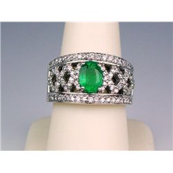 Gorgeous 14 karat heavy white gold ladies  intricate design ring set with a fern green  Emerald weig