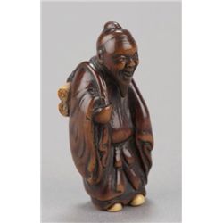 ,A wood netsuke of a Chinese scholar.