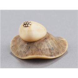An ivory netsuke of a mushroom.