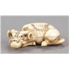 Image 1 : An ivory netsuke of a recumbent ox.