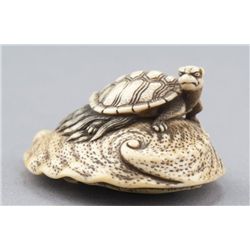 An ivory netsuke of a Minogame tortoise.