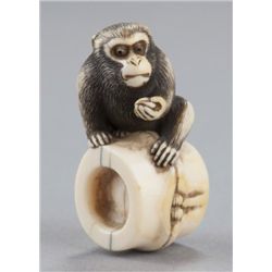 An ivory netsuke of a monkey.