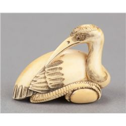 An ivory netsuke of a Manchurian crane