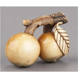 An ivory netsuke in the form of loquats.