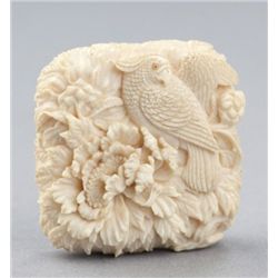 A fine ivory manju of a parrot.