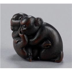 A wood netsuke of two monkeys.