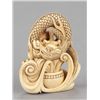 Image 1 : An ivory netsuke of a dragon emerging from an alms