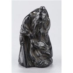 A black persimmon netsuke of Shoki.