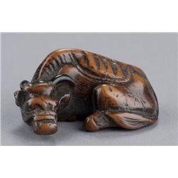 A wood netsuke of an ox.