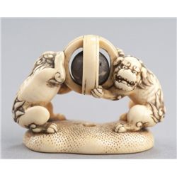 An ivory netsuke of a pair of Shishi.