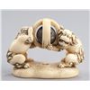 Image 1 : An ivory netsuke of a pair of Shishi.