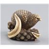 Image 1 : An ivory netsuke of a quail perched on millet seed