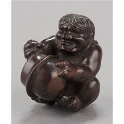 A wood netsuke of Oni.