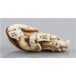 An ivory netsuke of a Tanuki.