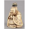 Image 5 : An ivory netsuke of a seated Court figure.