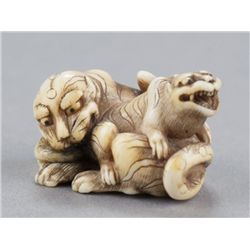 An ivory netsuke of two tigers.