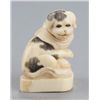 Image 1 : A narwhal ivory netsuke of a Piebald pup.
