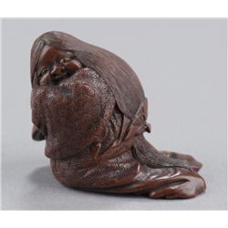 A wood shunga netsuke of Okama.