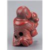 Image 5 : A carved tsuishu netsuke of a boy with puppy.