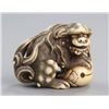 Image 1 : An ivory netsuke of a Shishi and a mokugyo.