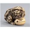 Image 2 : An ivory netsuke of a Shishi and a mokugyo.