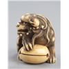 Image 3 : An ivory netsuke of a Shishi and a mokugyo.