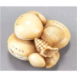 An ivory netsuke of a shell cluster.