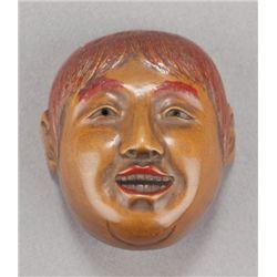 A boxwood netsuke of a Noh mask.