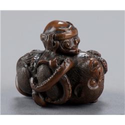 A wood netsuke of an octopus and a monkey.