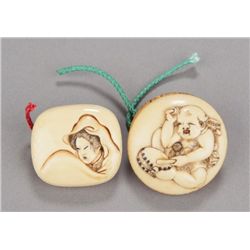 A group of two ivory manju.