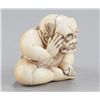 Image 2 : An ivory netsuke of a boy with a mask.