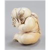 Image 4 : An ivory netsuke of a boy with a mask.