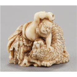 An ivory netsuke of Busho slaying the tiger.
