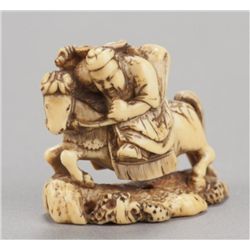 A ivory netsuke of Gentoku (Liu Pei) on horseback.