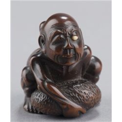 A ivory netsuke of a blind beggar.