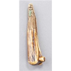 A stagshorn netsuke of tea grinding instruments.