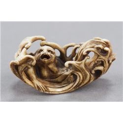 A stag antler netsuke of a mermaid.
